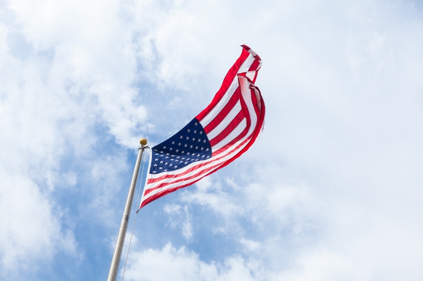 US Flag with blue sky.